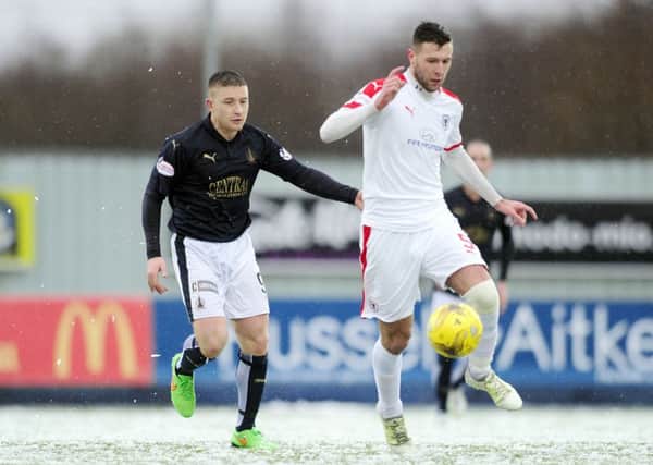Lewis Toshney screens the ball from John Baird at Falkirk Stadium on Saturday. Pic: Michael Gillen