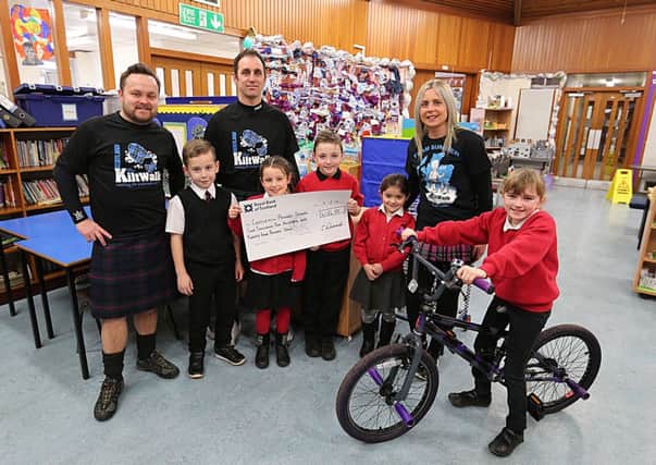 Pictured with the cheque for Â£4124 from the Kiltwalk are, from left - Darren Liddle, Brodie Wroniecki, Chris Wroniecki, Summer Wroniecki, Rio Seaton, Karina Crawford, Karen Wroniecki and Shannon Crawford (the top fundraiser, who was presented with a bike).