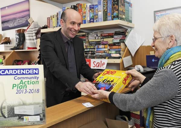 Community Empowerment Minister Marco Biagi purchased  'Glee' the board game from volunteer Helen Duff in the community-run charity shop.Pic: Neil Hanna