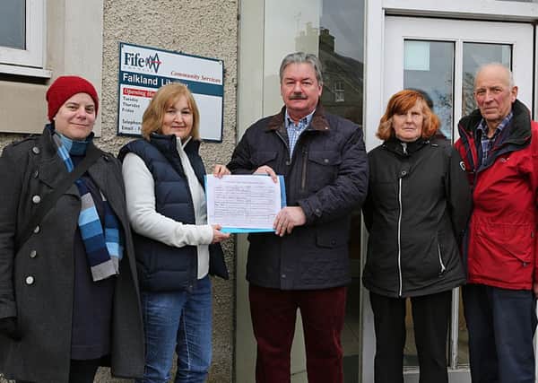 Pictured outside the library with the petition are, from left - Caren Gilbert, Rachel Fraser, Ken Laurie, Margaret Normand and Lars Christinsen.
