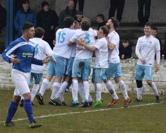 Kyle Wilson mobbed by his team mates after a sensational strike