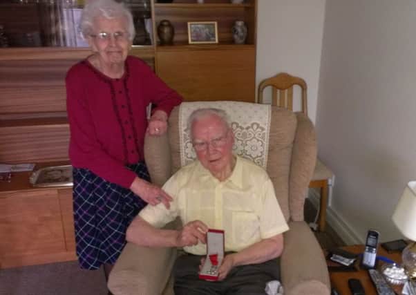 James and Janet Harrower, of Kennoway, with James' medal to acknowledge his role in the liberation of France just after D-Day in 1944.