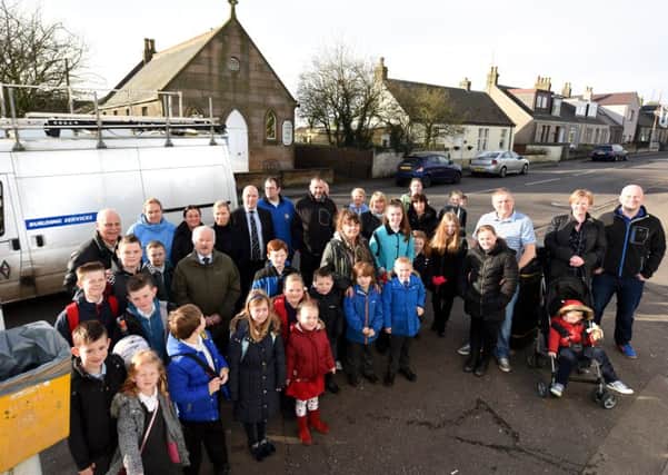 Cllr Ian Sloan with village residents complaining about Fife Council vehicles passing through Main St. Pic by FPA.