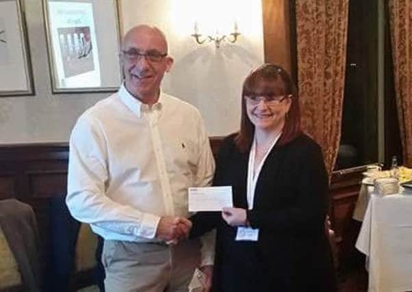 Alan Johnstone, of Dunfermline Round Table, makes the presentation to Liza Quin.