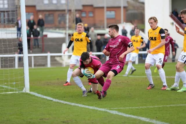 Liam Kelly deals with this Arbroath attack