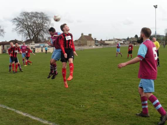 Darren Thomas challenges in the air for Cupar.