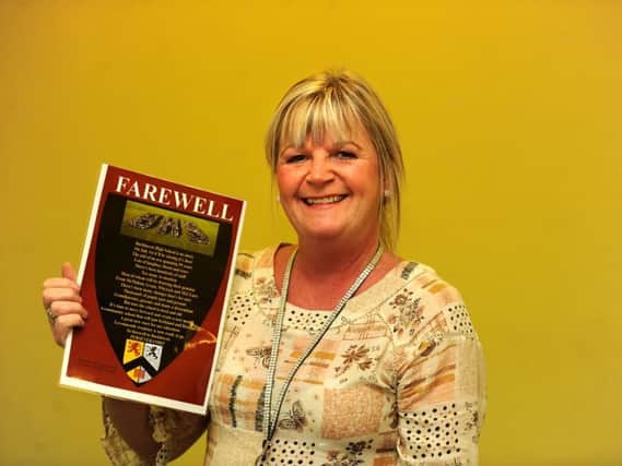 Wendy Morrison, with the poem which was given a special design by S3 pupil Jai Philp. Pic by FPA.