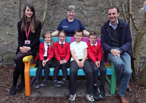 Some of the Ladybank youngsters trying out the bench, with P3/4 teacher Zara Gallacher (left), Tesco community champion Elaine Brailsford and local MP Stephen Gethins.