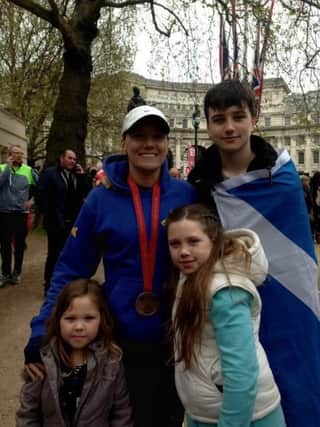 Karen Cunningham celebrating
with her family after running a fantastic time of 4:27 at the London Marathon.
