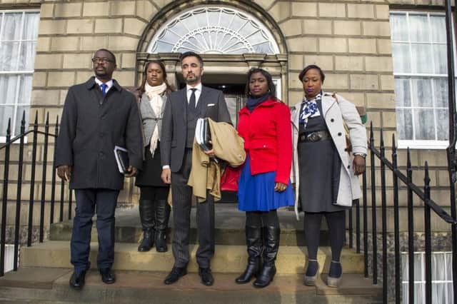 The family of the late Sheku Bayoh (pictured with their solicitor Aamer Anwar) have vowed to clear his name. Picture: Ian Rutherford.