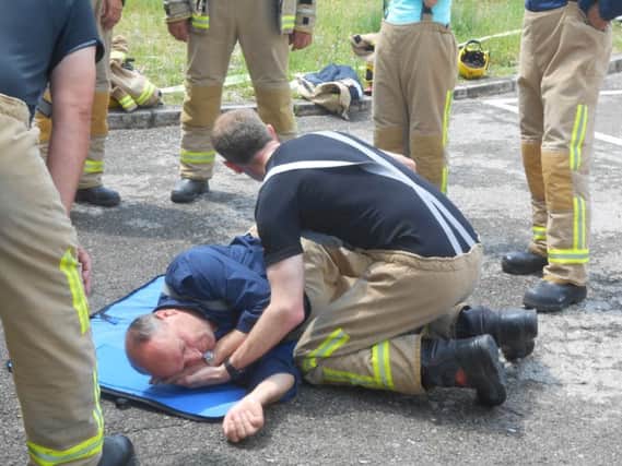 Fraser helps demonstrate first aid techniques to Bosnian firefighters on last years trip