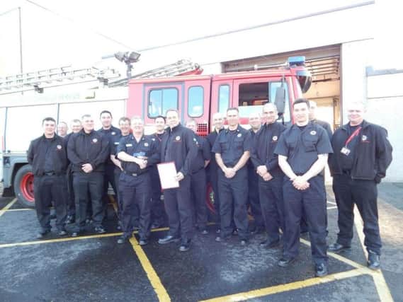 Firefighter Brian Ritchie  (right with certificate) at St Andrews Community Fire Station