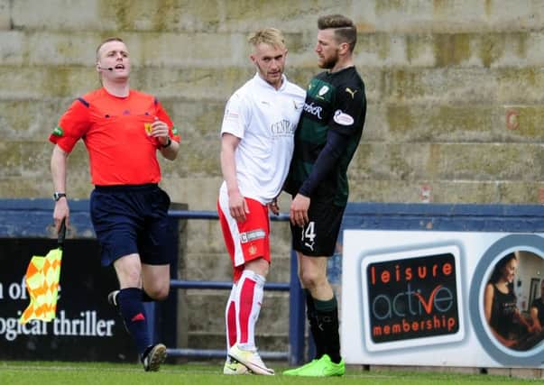 Iain Davidson (right) squares up with Falkirk's Craig Sibbald during Saturday's 2-2 draw. Pic: Michael Gillen