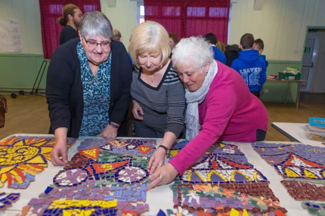 Galatown Community Members all get together to make a mosaic to help brighten up the surrounding area. Pupils from P7 at Pathead Primary and Gala Craft Group all muck in to create the colourful artwork. Margaret Collier, Janet Dunne and Julia Dunlop