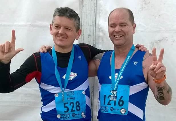 Robin Pate and Davie Hogg celebrate after finishing the Belfast City Marathon