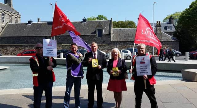 Members of Unison are joined by Alex Rowley and Claire Baker at Holyrood to protest against cuts to NHS Fife's budget.