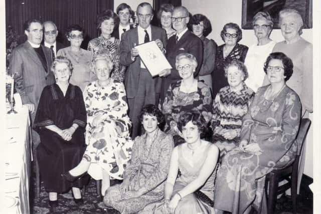 Committee members are presented with a certificate for their fundraising in 1976