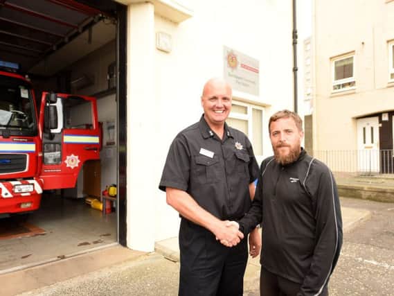 Fire chief officer Lee Mahady is pictured with Wayne at Burntisland Fire Station. Picture by FPA.