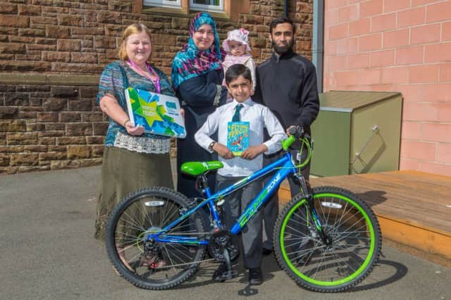 Left: Maggie Gray ( OnFife), Sadia Ahmad, Baby Qayla, and Dad Saeed Ahmad with Daanyaal at the front with his brand new bike. Picture by Steven Brown Photography.