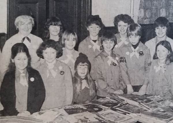 Girl Guides and Brownies pictured at their Blue Peter Bring & Buy stall in St Andrews Parish Church in February 1981
