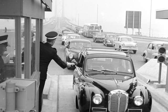 Forth Road Bridge traffic - a driver pays the toll in 1964.