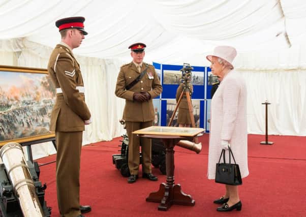 Martin (left) stood beside replicas of the Koehler Gun used in the Seige of Gibraltar 1779-1783, gives his presentation to Her Majesty. Â© MOD Crown Copyright. Cpl Daniel Wiepen RLC (Phot)