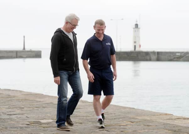 Brian Clarke and Stuart Barton at Anstruther Harbour just metres from where Startu delivered a lifesaving shock to Brian's heart.
