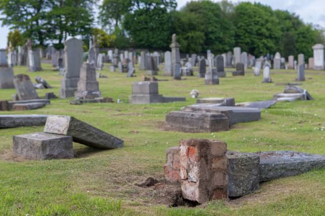 Headstones were damaged and pushed over. Pic: Steven Brown.
