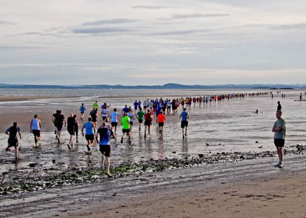 Runners head out across the beach in a previous Black Rock 5.