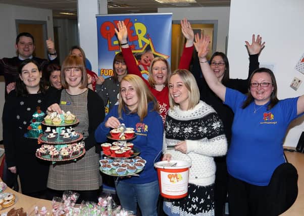 Jennifer Gill, front centre, and other supporters with staff from Rollos of Glenrothes at a LoveOliver cake bake (picture by Dave Scott)