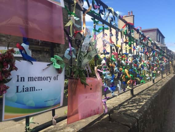 Tributes are paid to Liam on the church railings