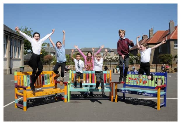 Freya, Katie, Taha,  Linda Sutherland, Murray, Louis and Imogen jump for joy as the benches are unveiled.