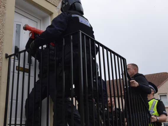 Officers force entry into a property in Dunsire Street, Kirkcaldy. Pic: George McLuskie