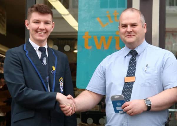 Stephen Docherty accepts a donation of Â£50 from Ian Jones, Sainsbury's store manager to put towards food for the pupils taking part in the Madras College 24 hour Sportathon.