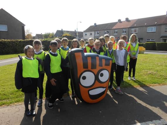 Pitteuchar West Primary pupils hand over mascot Strider to youngsters from Rimbleton Primary.