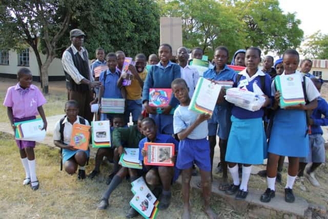 Schoolchildren in the village of Chikoore in Zimbabwe with the latest delivery of books for the Gogo Grace Mutemasango Library, set up by St Andrews nurse Wilma Sweeney.