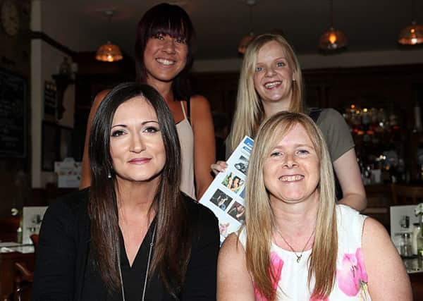 Preparing for the quiz, from left, front - quizmaster Lorna Lidderdale and Jillian Wallace; back - Debbie Reilly, Lauren Reilly.