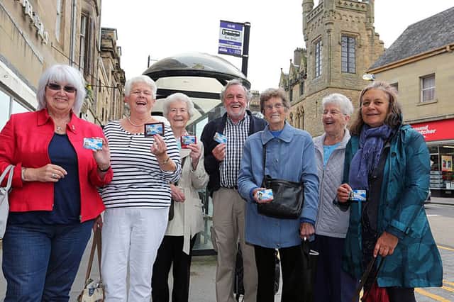 Happy passengers with their bus passes: from left, Dorothy McIntosh, Nadie Willard, Margaret Harris, Keith McIntosh, Agnes Laing, Betty Watson and Ingrid Haas.
