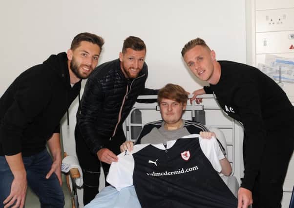 Bradley Sharp enjoys a visit from Raith players, from left, goalkeeper Aaron Lennox, Iain Davidson and Kevin McHattie