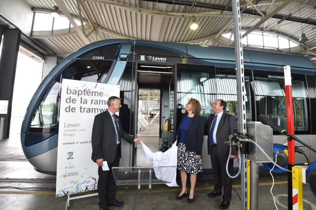 Councillor Tom Adams, chairman of the Levenmouth area committee representing the area at the unveiling of a new tram, 'Leven', part of the Levenmouth twinning agreement in Bruges. Pictured with Christophe Duprat, Vice-President of Bordeaux Metropolis Delegate to transport and Brigitte Terraza, Mayor of Bruges