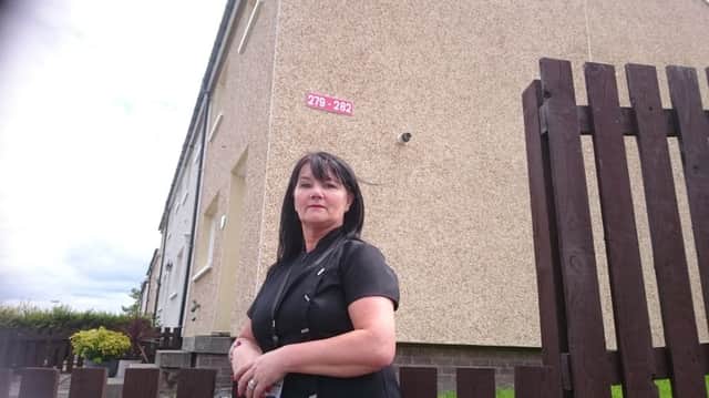 Trish Dingwall with the wrong house number sign in Redcraigs
