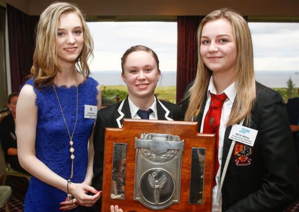 Last years Stuart Trophy winner Lisa Whyte hands over the trophy to Amber Strachan (centre) and Beth Milloy.