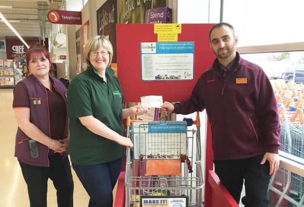 Alison Nelson (former coordinator at Levenmouth Foodbank) with Sainsbury's Leven staff