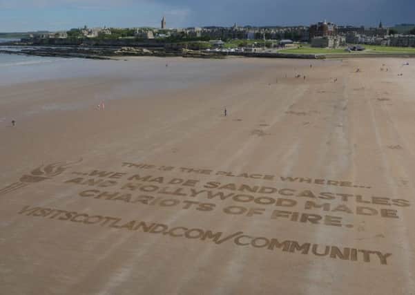 West Sand beach - Sand Art activity VisitScotland promotes St Andrews with new sand writing drone video.
