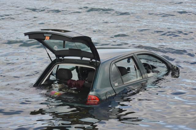 The car sinks into the water. Picture by George McLuskie.