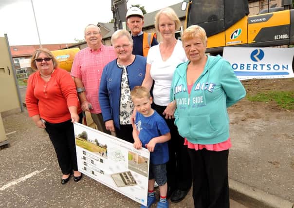 Members of the local community and Overton Community Association hold up plans for the new Overton Community Centre - Pic by Fife Photo Agency