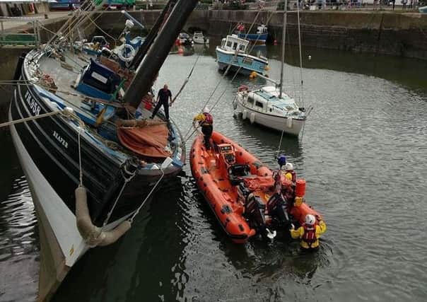 Emergency services tried to right the vessel. Photo courtesy of HM Coastguard Angus & Mearns.
