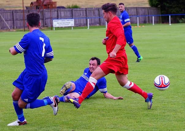 Dundonald's Scott Mayne makes a sliding challenge during the game against Camelon. Pic: George Wallace
