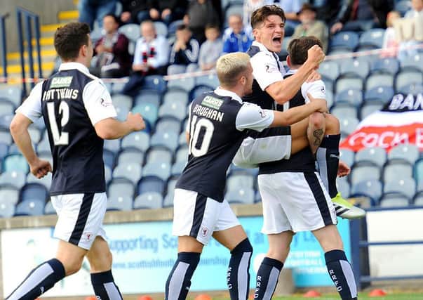 Declan McManus celebrates with Ross Callachan and Lewis Vaughan after opening the scoring against St Mirren. Credit - FPA