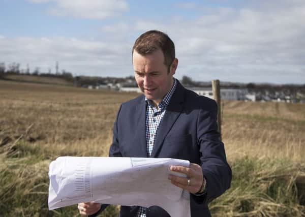 St Andrews councillor Brian Thomson looks at plans for the new Madras College at the Pipeland Farm site.